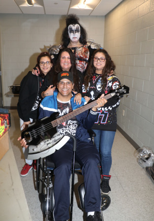 Family with Gene Simmons, signed over his axe 